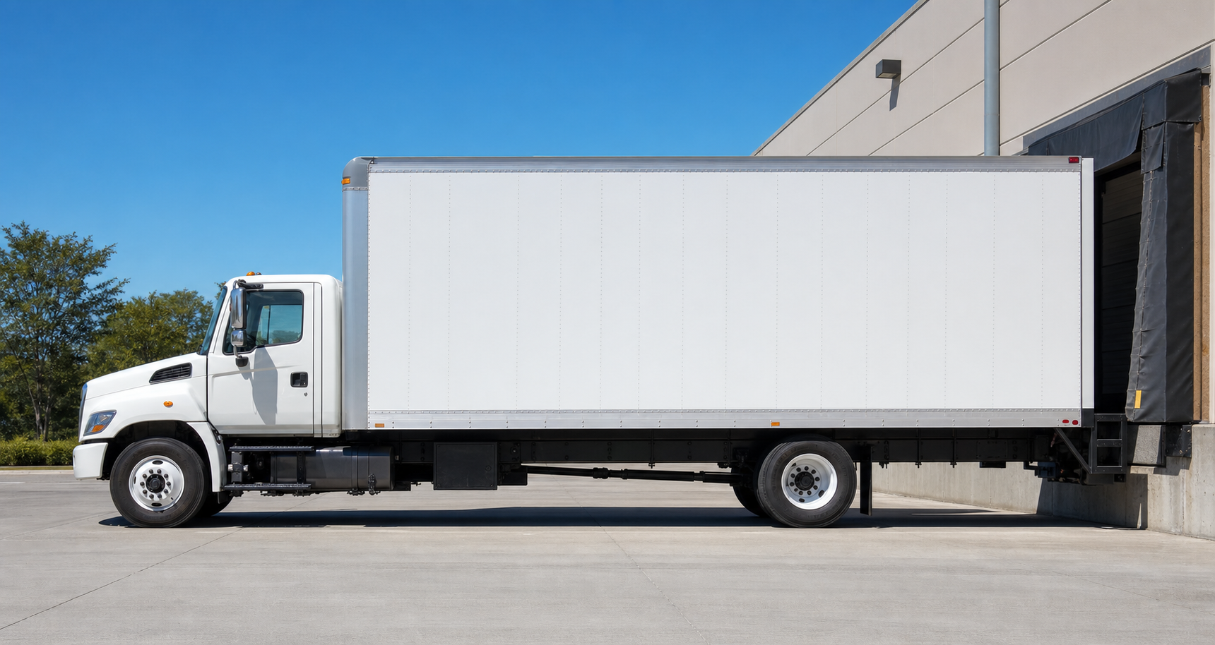 Straight box truck being loaded at a dock