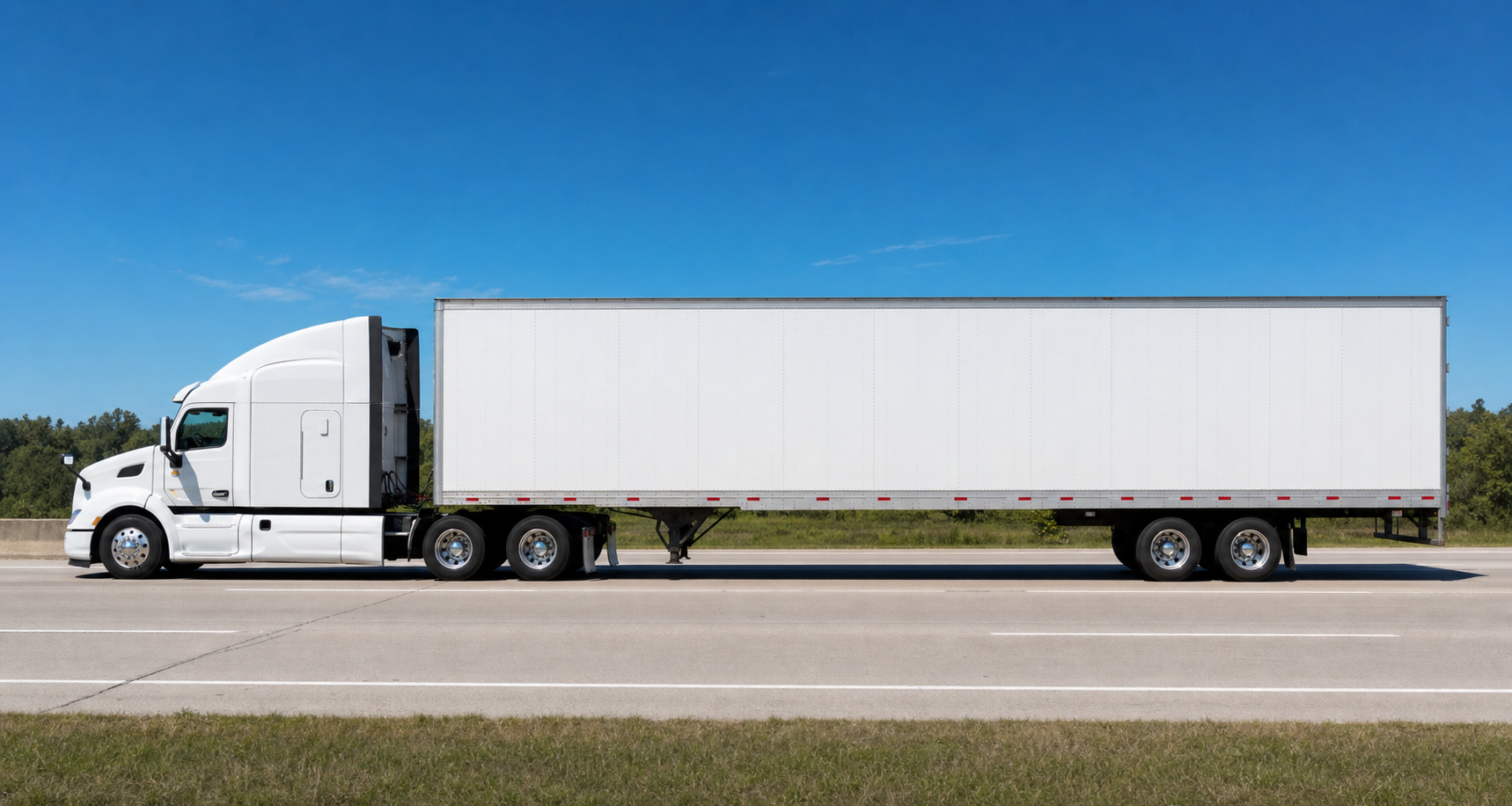 White dry van semi-truck trailer driving on the highway