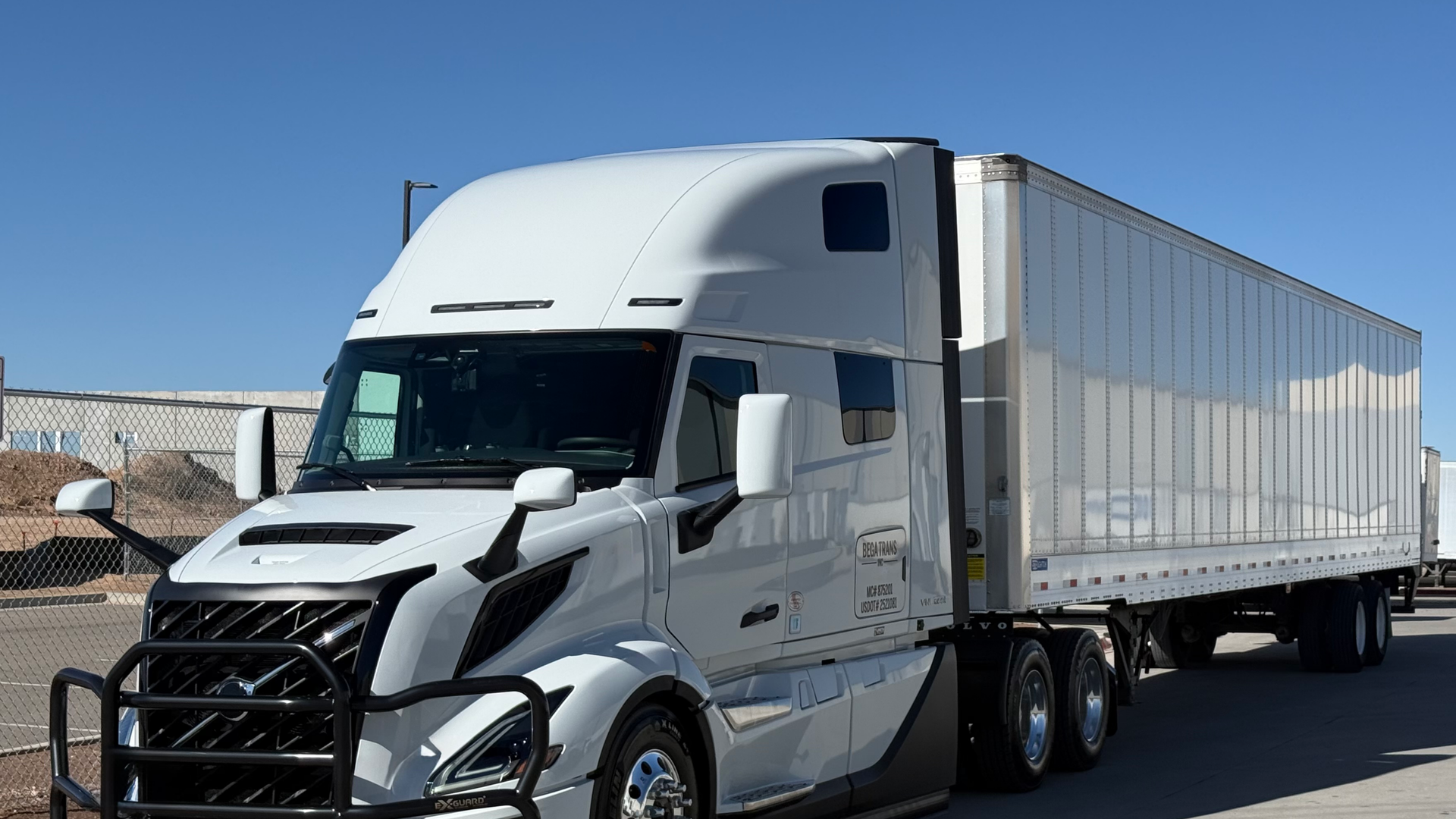 Semi-truck driving on an American highway at dawn